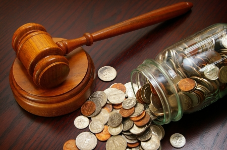 16434972-legal-gavel-and-coins-in-a-coin-jar